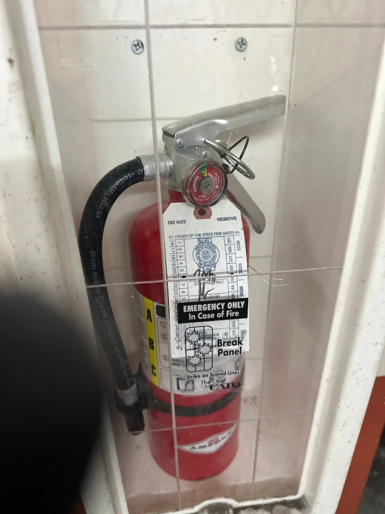 Wall-mounted Amerex fire extinguisher with official California State Fire Marshal annual inspection tag EE 20911 at 5 Seymour St by International Fire Inc.