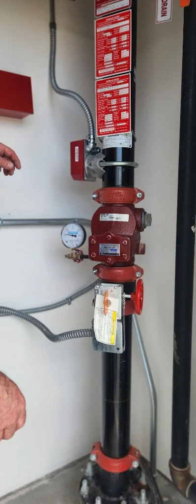 Viking fire sprinkler riser assembly with pressure gauge, flow switch, and hydraulic data placards at 130 San Miguel Way in San Mateo, CA by International Fire Inc.