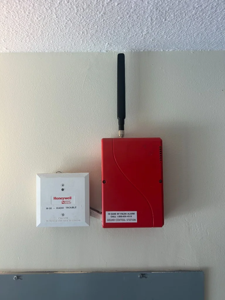 Honeywell Silent Knight radio communicator mounted next to a radio trouble box