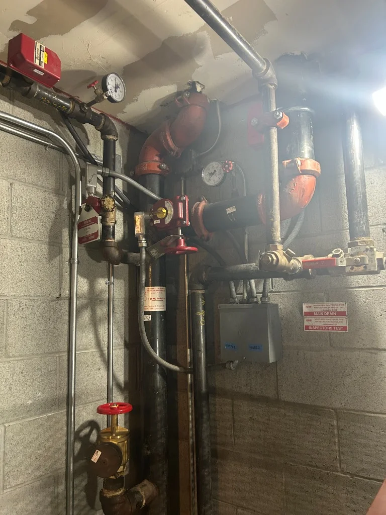 Fire sprinkler riser pipes featuring a waterflow switch, tamper switches, and pressure gauges