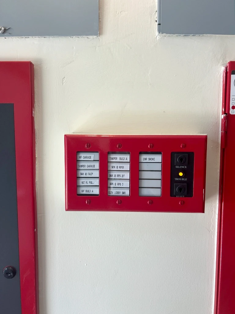 Red fire alarm remote annunciator panel with zone LED status lights and keyswitch tested in Mission District, San Francisco by International Fire Inc.
