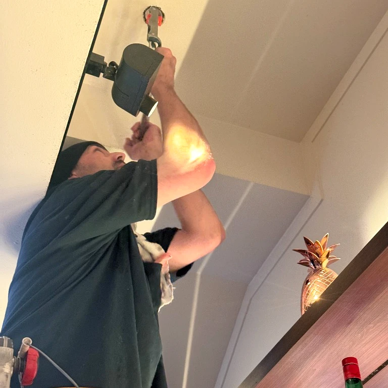 International Fire Inc. licensed fire protection technician replacing a Viking fire sprinkler head in a Richmond District residential building ceiling.